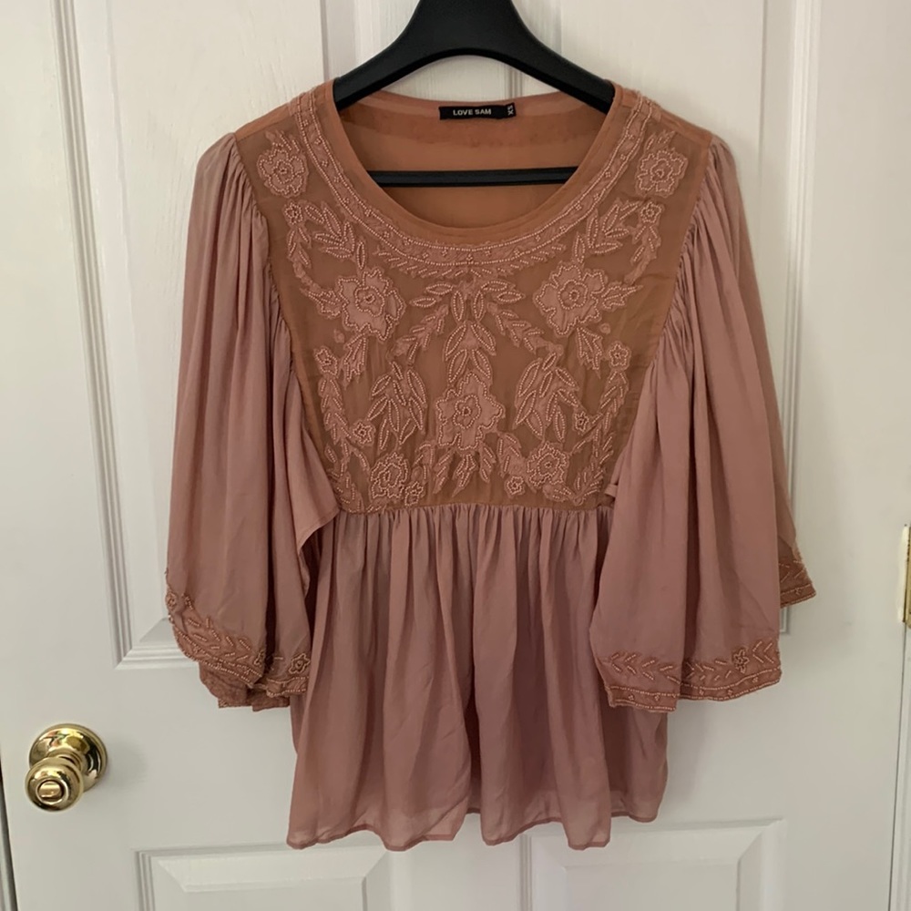 Blush top with embroidery, beading, and sheer back